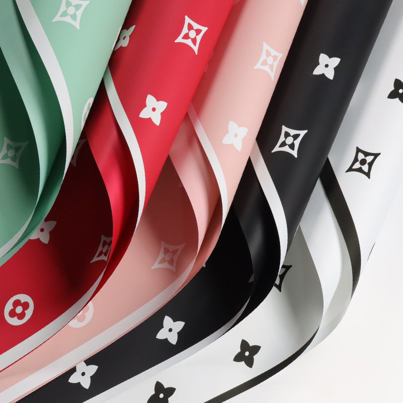 Valentine's floral paper pack featuring elegant red roses and romantic designs, perfect for crafting love-themed projects.